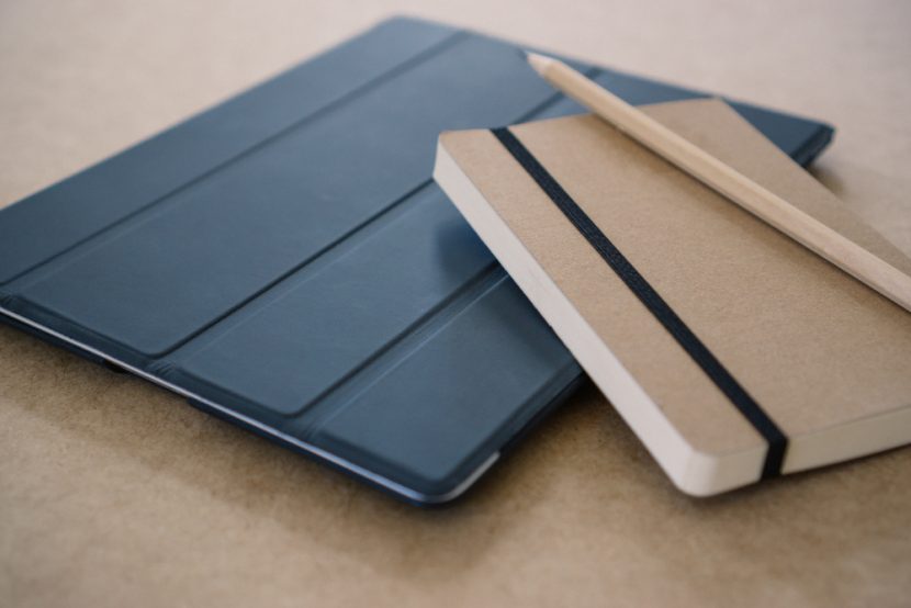 a notebook with a pencil on a table